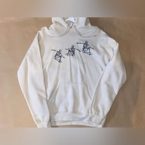 Tan hoodie with skeletons skateboarding